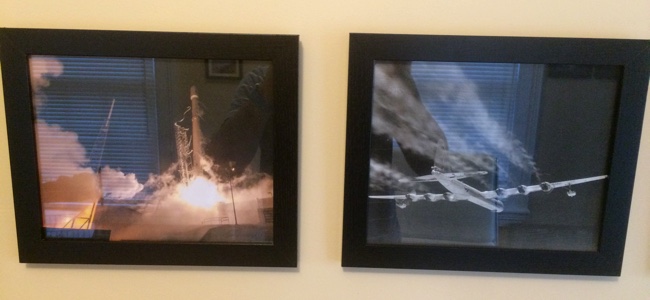 Framed photos of a Falcon 9 launch, and a Convair B-36 in flight