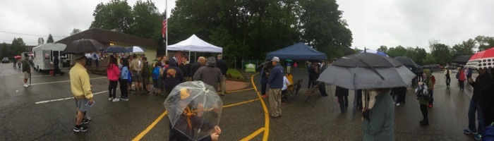 gathering in the rain for Memorial Day ceremony